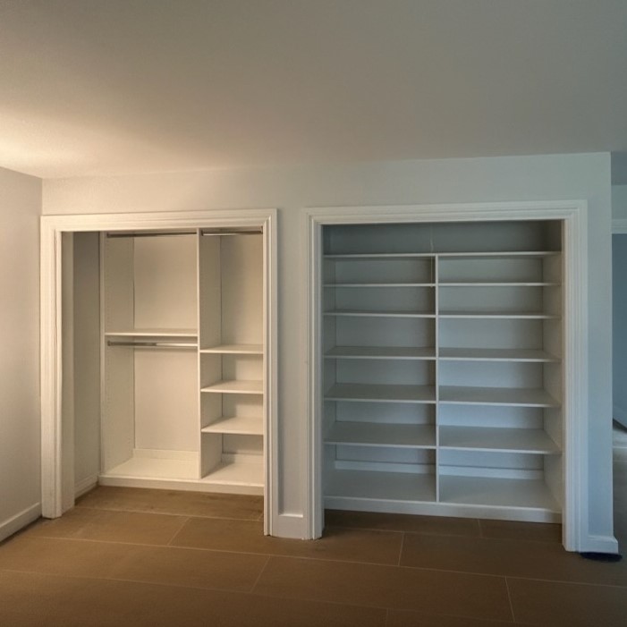 Custom Reach In Closet Featuring Double Closet Space With White Shelving And Integrated Storage.