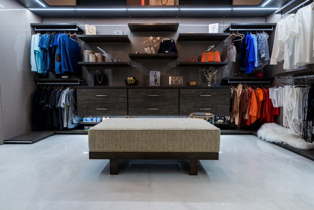 Luxury Custom Walk-In Closet In Naples, Florida, Featuring Dark Wood Cabinetry, Open Shelving, Built-In Drawers, And Integrated Led Lighting For Best Custom Closet Solutions Near You.