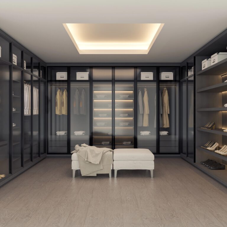 Modern Walk-In Closet With Integrated Shoe Storage, Slanted Racks, Glass Doors, Custom Drawers, And Plush Seating.