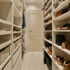 Walk-in closet with custom shelving, shoe storage, and pull-out drawers for small spaces.