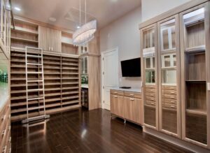 Cabinets and shelves in light oak finish by JL Closets