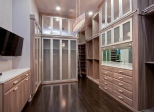 Dream closet design in light wood theme by JL Closets.