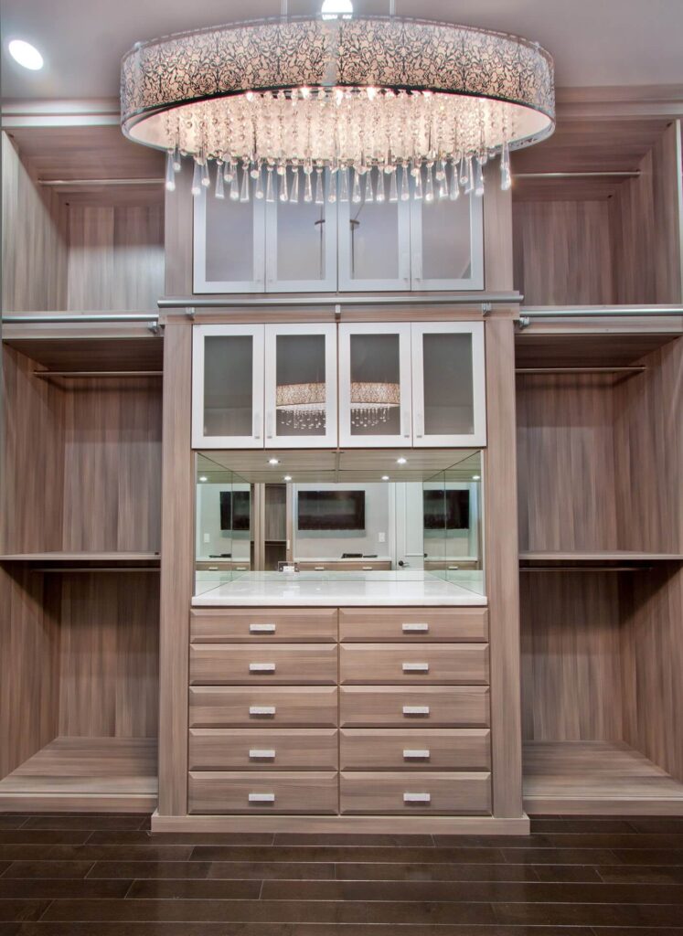 Luxury walk in closet with cabinets and shelving system