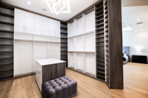Modern walk in closet in medium dark wood and pearl white finish