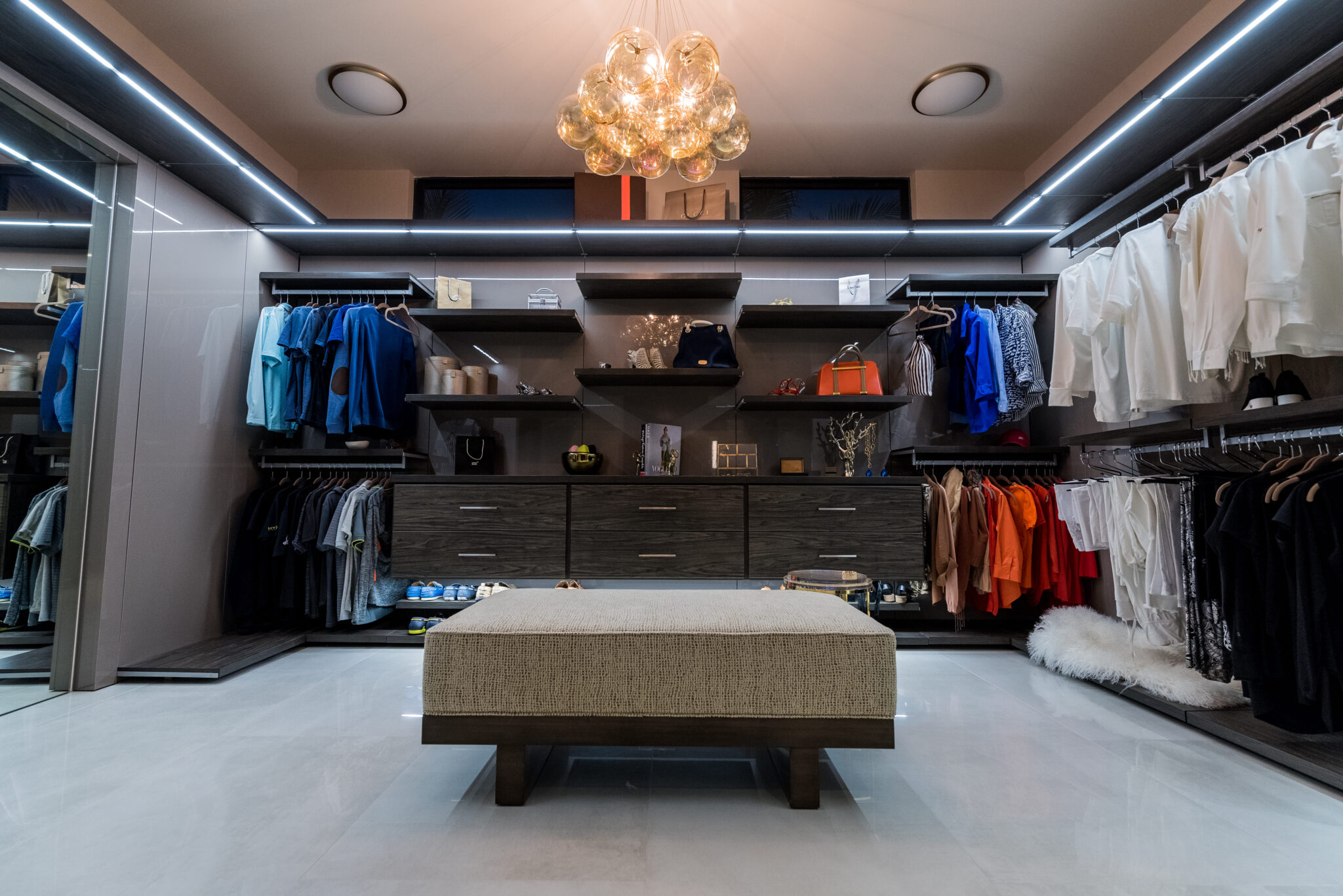 Custom modern walk-in closets with integrated lighting system.