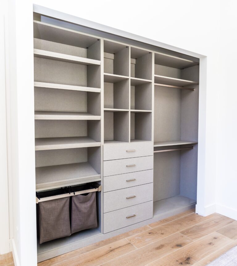 Modern Reach-In Closet With Custom Shelving, Drawers, And Integrated Storage Bins For Efficient Organization.