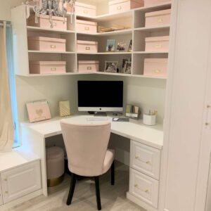 Small corner home office with custom shelving and storage