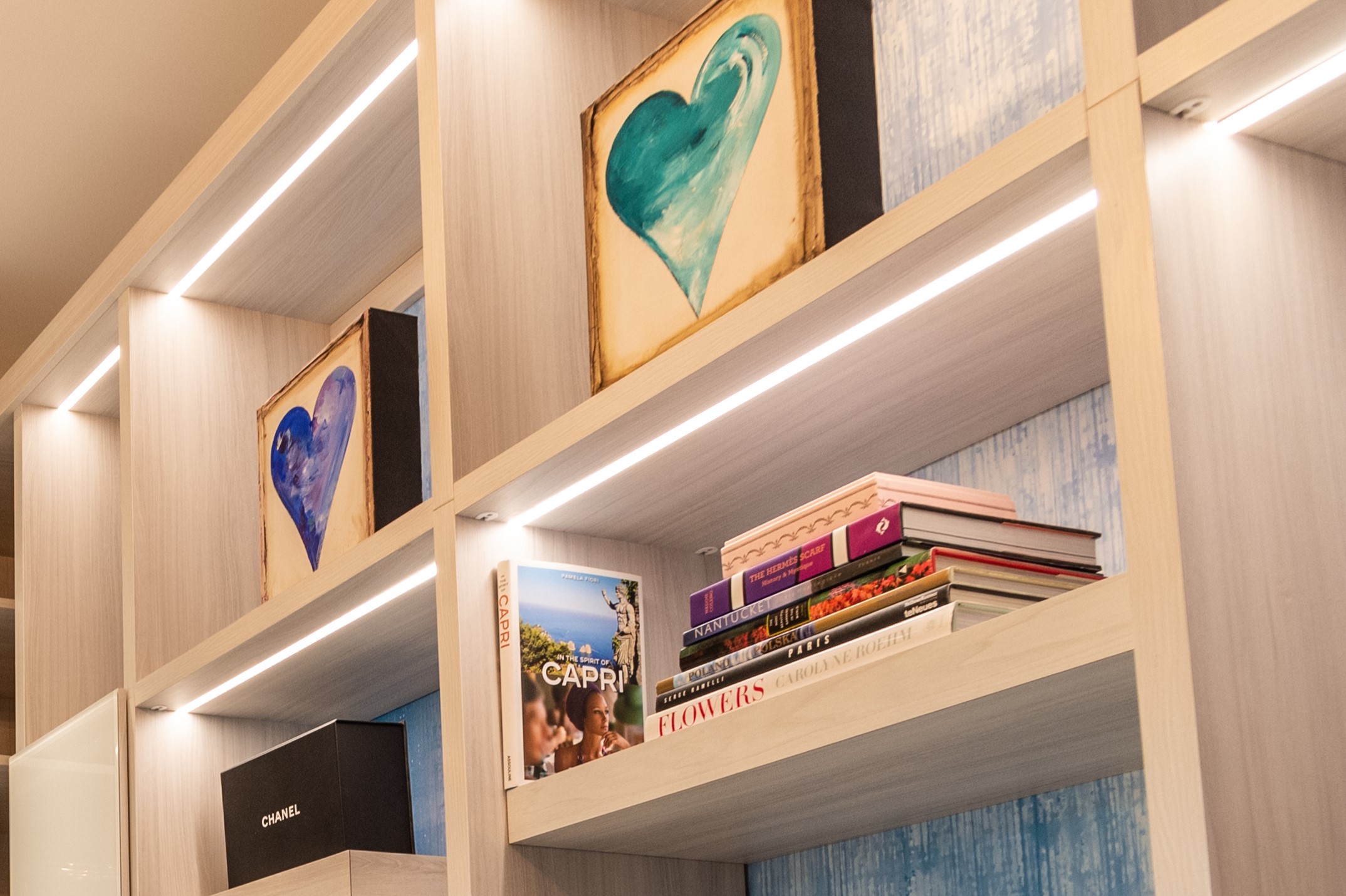 Custom closet systems Boca Raton with built-in shelf lighting and modern wood display units by JL Closets, combining function and luxury storage solutions.