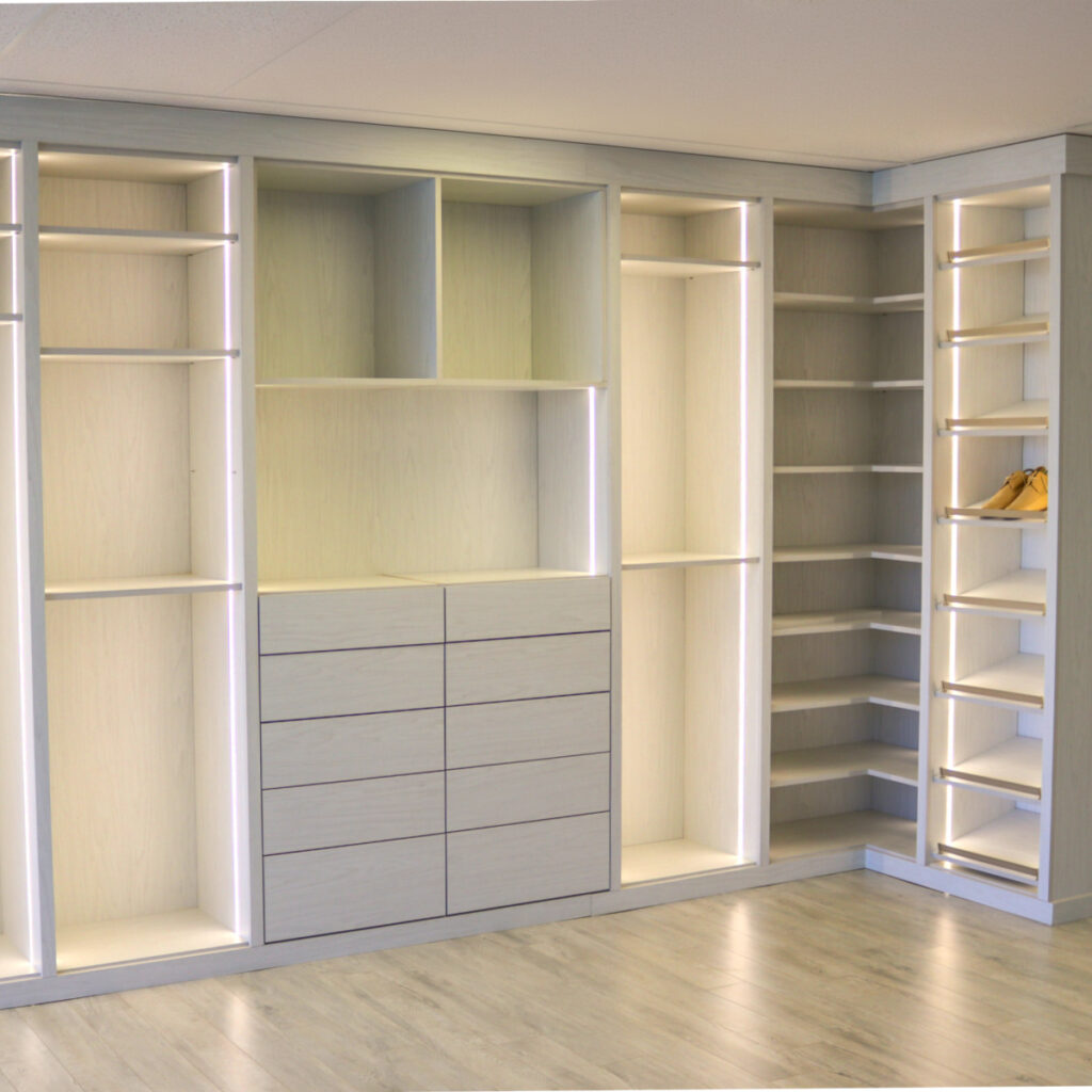 Custom closet system installed in a Boca Raton home featuring integrated closet lighting, sleek wood drawers, adjustable shelving, and a built-in corner shoe organizer. Designed by JL Closets Boca Raton, trusted for custom closets Boca Raton and closet systems Boca Raton.