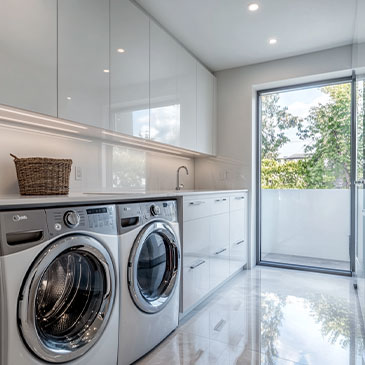 Modern Laundry Room With Custom Cabinets For Efficient Storage And Organization.