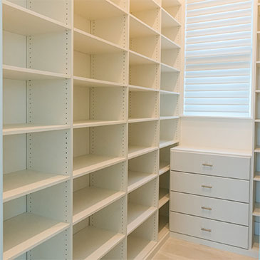 Custom pantry shelving with adjustable racks for maximizing space and storage.