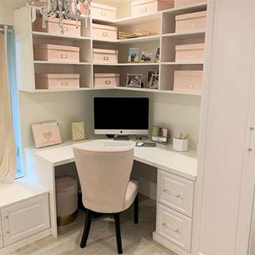 Tiny home office showcasing efficient corner space utilization with custom shelves and desk, perfect for small space storage solutions.