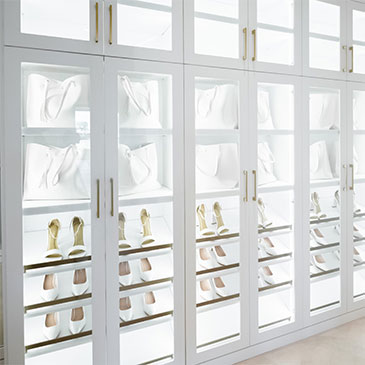 Luxury Custom Shoe Storage Closet With Illuminated Shelves Displaying Designer Handbags And High Heels.